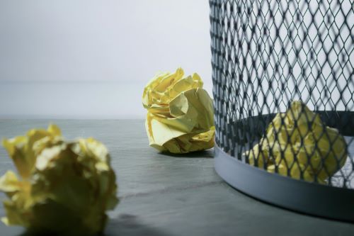 Trash can with crumpled papers by Steve Johnson via Pexels.